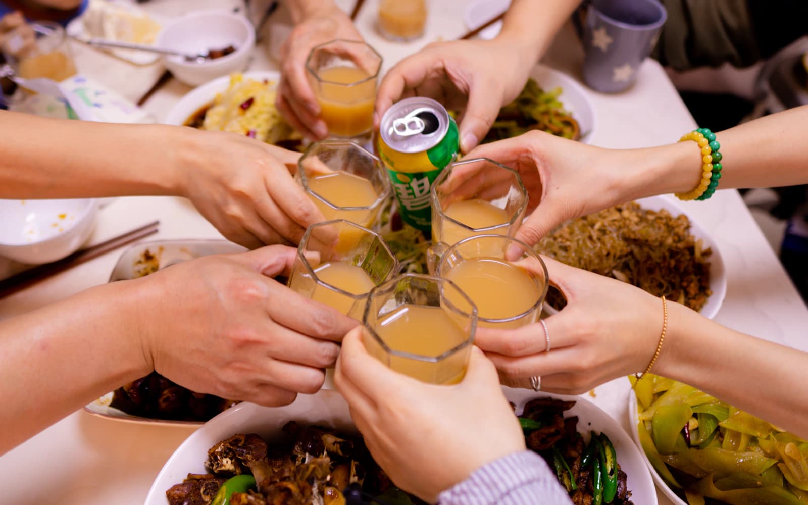 Friends raising their glasses around a dinner table
