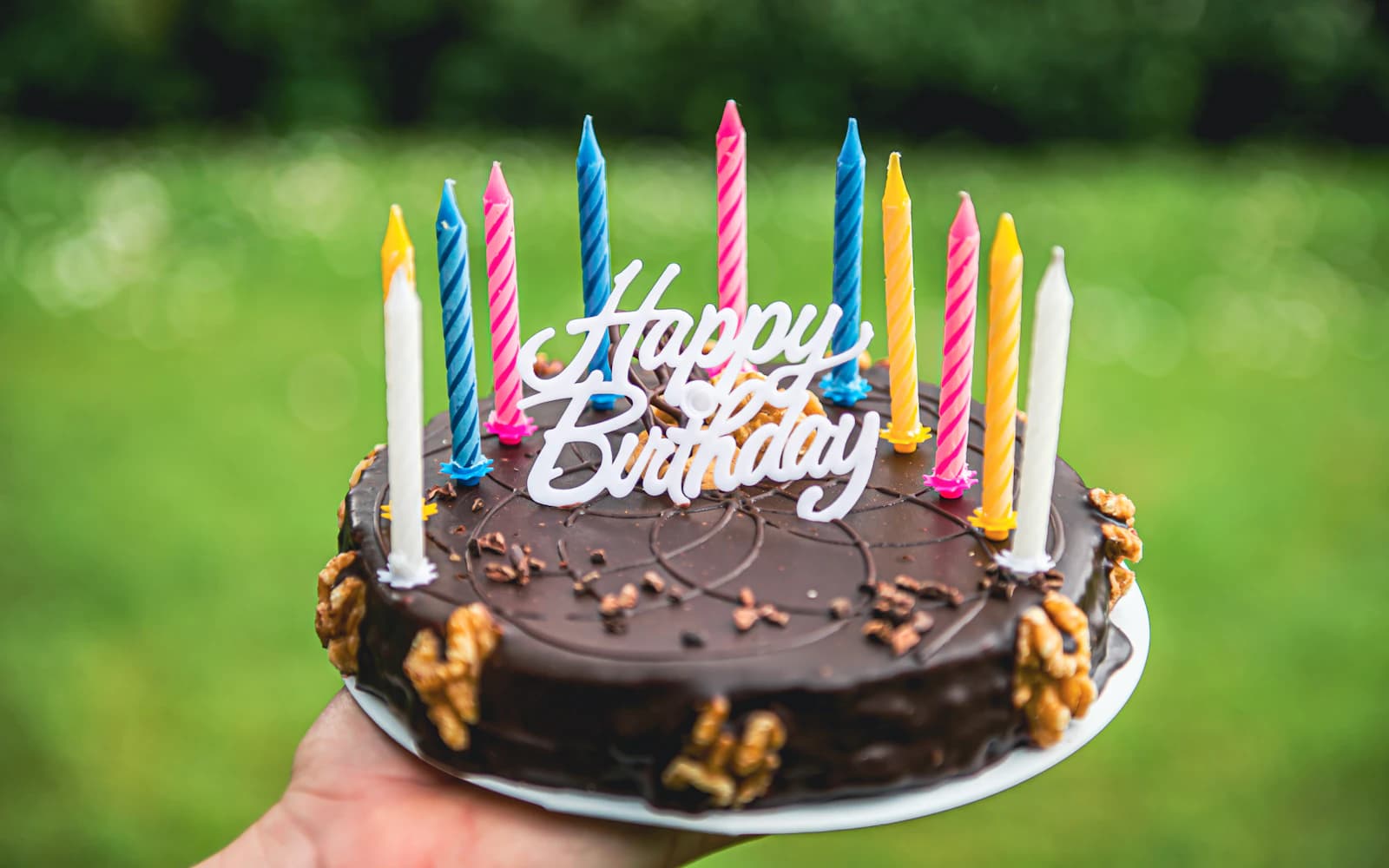 Birthday cake topped with colorful birthday candles