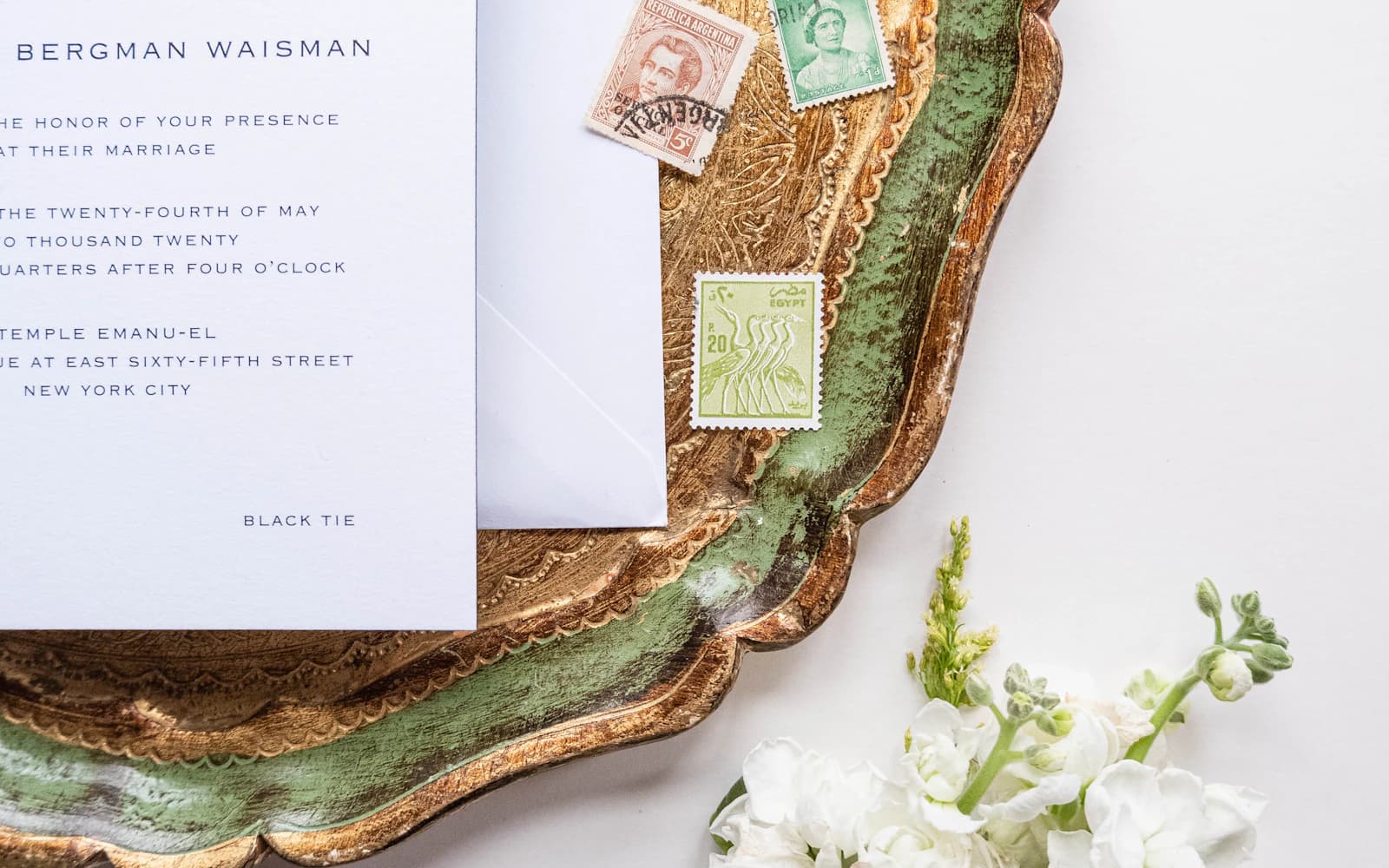 Close-up of wedding invitation stationery on a decorative plate