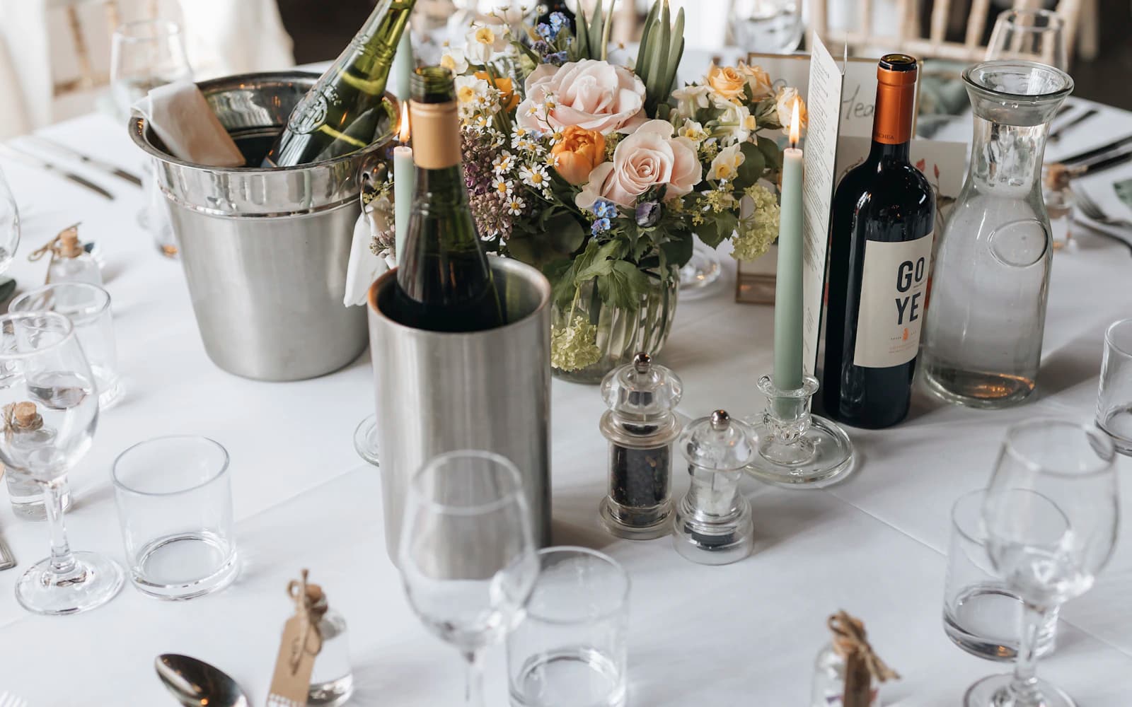 Wedding reception table set with flowers, glasses, and place settings