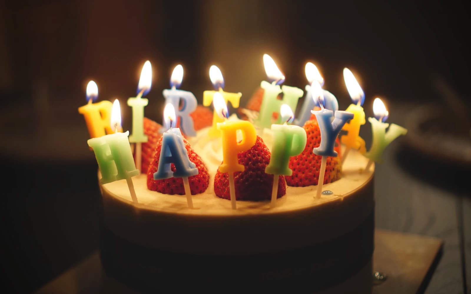 Birthday cake decorated with happy birthday candles